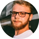 A man with a beard wearing glasses.
